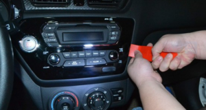 Pry the trim panel of the radio with a plastic knife and remove it. Unplug the connector at the back of it