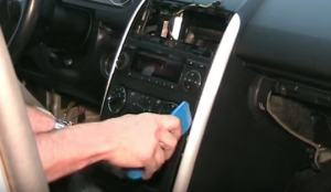 Remove the trim panel with a plastic removal tool