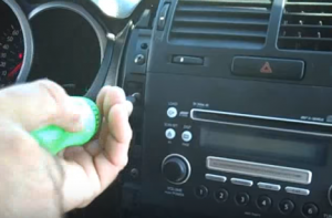 Unscrew mounting screws that are holding the radio and the AC control