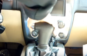 Move the shift lever down to the lowest position. So you can have enough room to get access to the radio