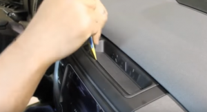 Remove the two upper dashboard trim panel retaining screws