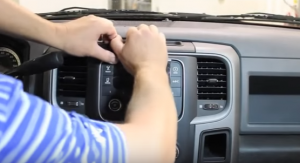 Gently pry the outer edges of the radio trim panel to remove it from the dashboard