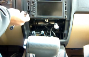There are four screws holding the radio. Use a screwdriver to remove these four screws