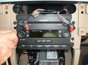 Remove screws securing radio to the vehicle, and take the original radio out of the dash