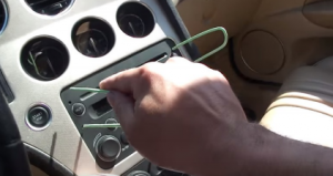 Put one end of the cutting hanger into two holes in one side of the original radio, and the other end into the other holes