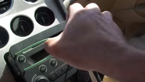 Take the original car radio out of the dash by pulling the cutting hanger
