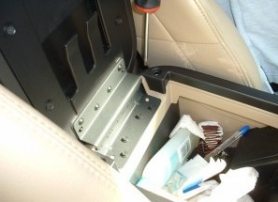 Remove screws securing center console lid with a screwdriver