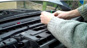 Then remove screws holding the radio in dashboard with a Phillips screwdriver as the picture shows