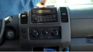 Use a screwdriver to remove two screws above the original car radio