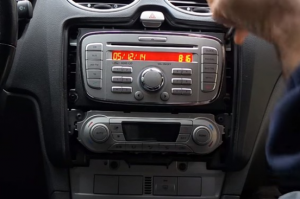 Unscrew four screws holding the original radio with a screwdriver