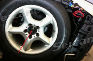 Remove screws in the spare tire in the trunk