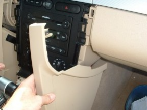 Remove console side panels on both driver and passenger sides