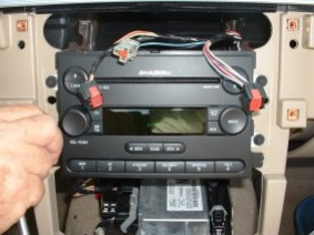 Remove screws securing radio to the vehicle, and take the original radio out of the dash