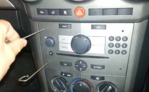 Put four removal sticks into four holes of the original car radio