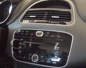 Insert the release keys in the removal slots of the car radio