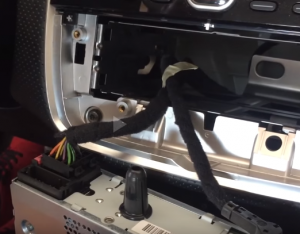 Disconnect the wiring loom and the aerial lead to release the car radio