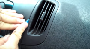 Pry the right air conditioner vent with a lever, and then remove it