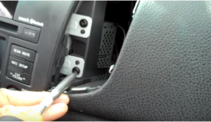 Unscrew four screws under the a/c vent holding the original car radio with a screwdriver