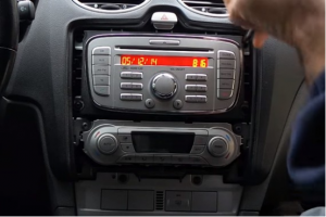 Unscrew four screws holding the original radio with a screwdriver