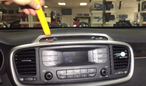 Use a plastic removal tool to remove the car radio trim panel