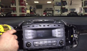 Remove the four screws that fix the original car radio on the dashboard