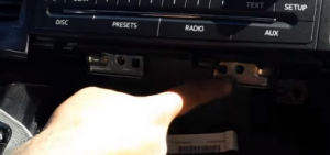 Remove the screws holding the factory radio in place with a screwdriver
