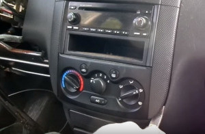 Pry the surrounded panel out of the dash with a plastic knife