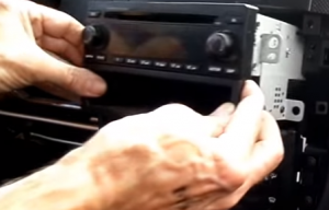 Gently pull the factory radio out of the dash