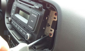 Remove four screws that fixed the radio on the dashboard