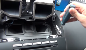 Use a screwdriver to remove the screws that are holding the original car radio