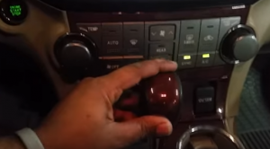 Move the shifter lever so as to get access to the bottom A/C panel below the radio