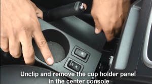 Unclip and remove the cup holder panel in the center console