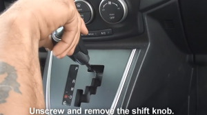 Unscrew the shift knob and remove it carefully