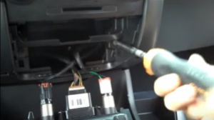 Remove two screws holding the console panel in place with a Phillips screwdriver