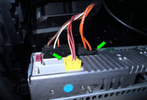 Pull out the connectors at the back of the stereo (green arrows). Note that some cars may have different setups based on the vehicle's different years