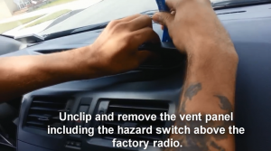 Unclip and remove the vent panel including the hazard switch above the factory radio. Then it will be much easier for you to get access to the screws. And remove the two screws