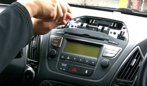 Unscrew two top screws fixed the radio on the dashboard