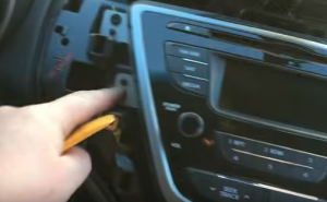 Remove 4 screws that fixed the car radio on the dashboard