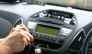 Remove another two screws that fixed the radio on the dashboard