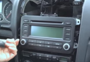 Unscrew four screws holding the original car radio with a screwdriver