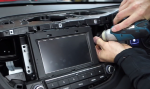 Use a screwdriver to remove four screws that hold the original car radio on the dashboard