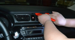 Use a plastic removal tool to release the top panel