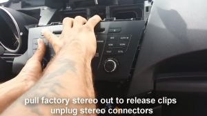 Pull factory radio out, release clips and unplug radio connectors