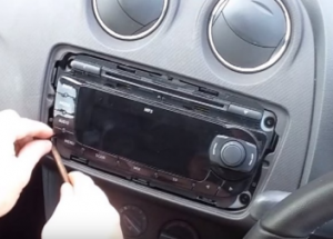 Remove four screws holding the radio in the dashboard with a screw driver