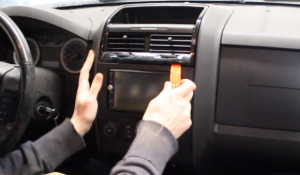 Prepare a flat plastic removal tool and use it to pry the air vent