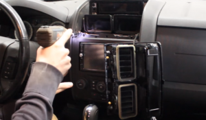 Use a screwdriver to remove the four screws that are holding the car radio