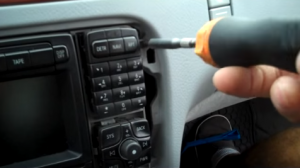 Remove four T20 Torx screws that are holding the radio on the dashboard