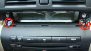 Remove two screws that fixed the car radio on the dashboard