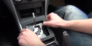 Remove the plastic part around the shift lever