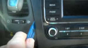 Remove the radio trim panel with the plastic removal tool and then unplug the connector at the back of it